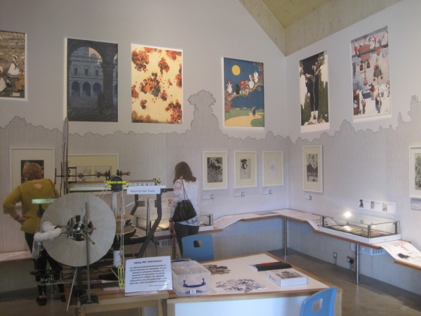 The Heath Robinson Museum showing the waist-level information shelf, mid-height prints, and high-up posters, plus the model contraptions in the middle
